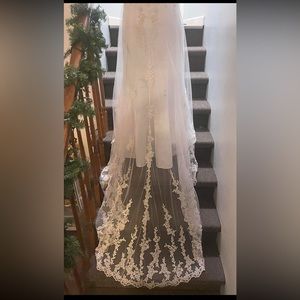 Only worn once! Size 8 strapless wedding gown with long lace train and bustle